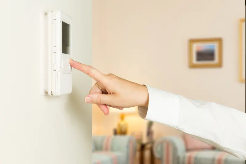 Person changing thermostat